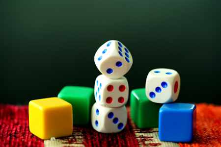 Collection of dice and plastic counters for board games.